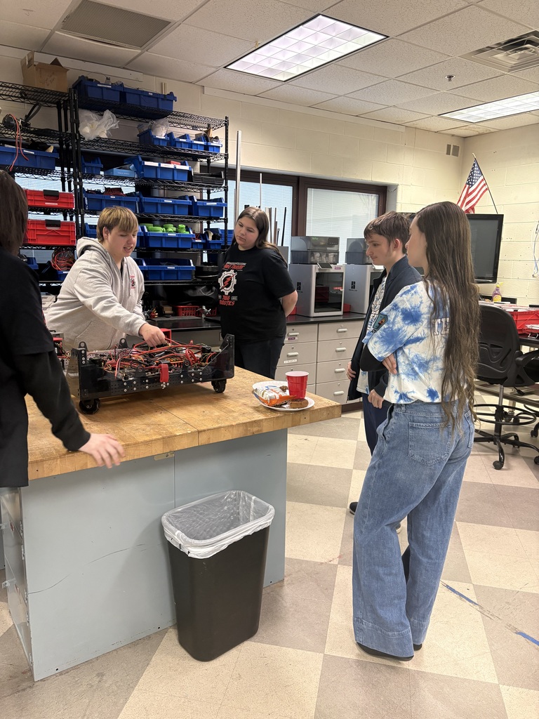 Students standing around a work bench
