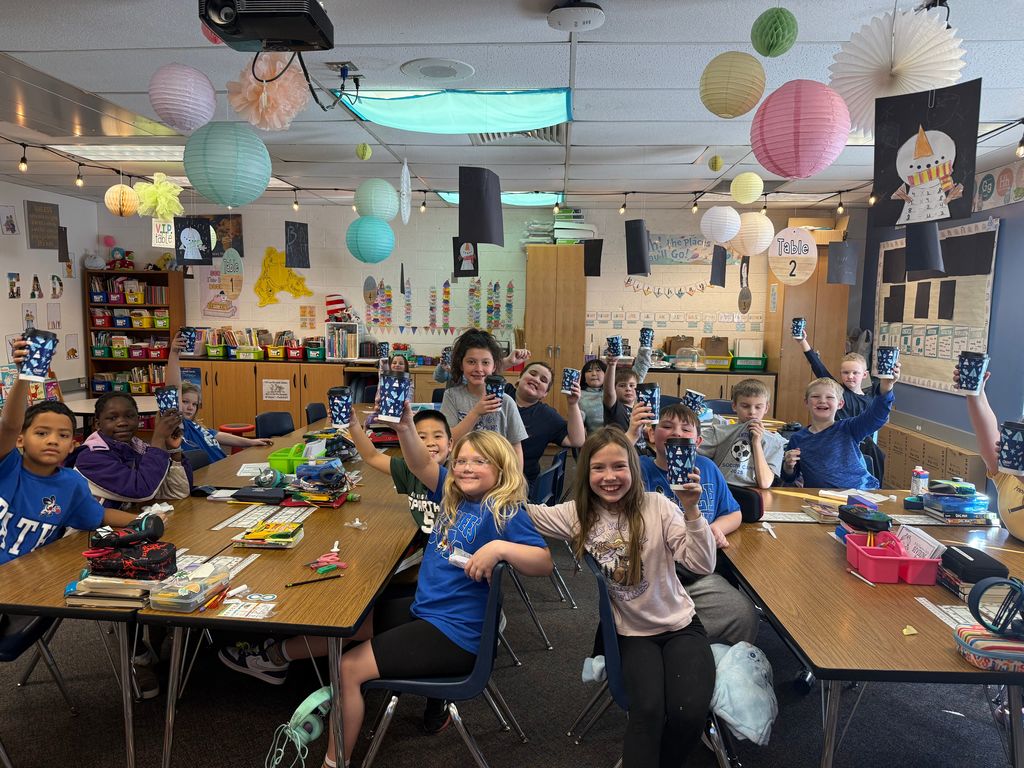 Students holding  cups of hot chocolate