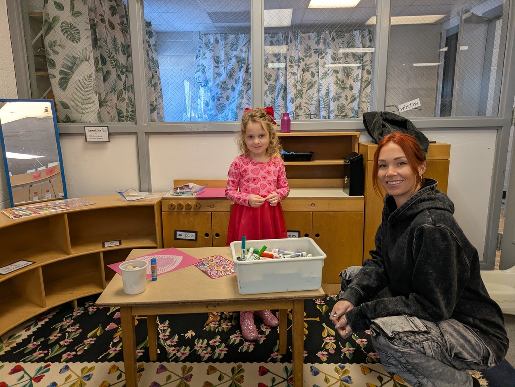 Girl and parent making valentines