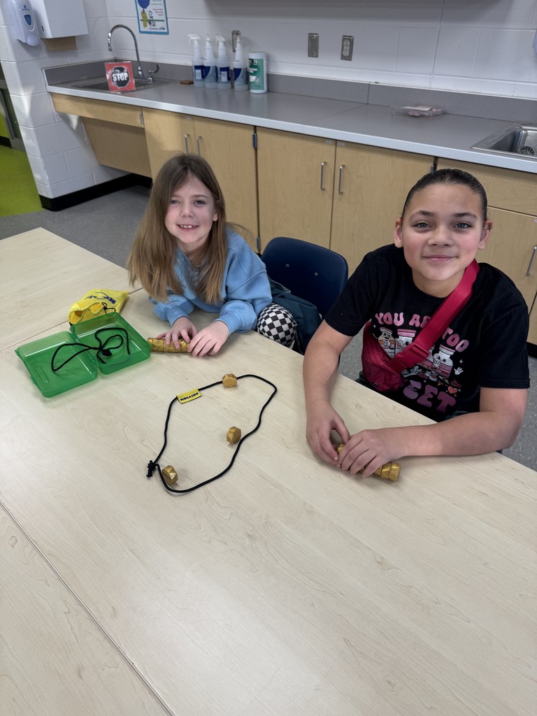 2 girls making a craft