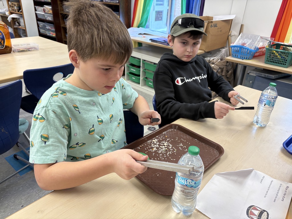 Boys sitting at table with sound fork