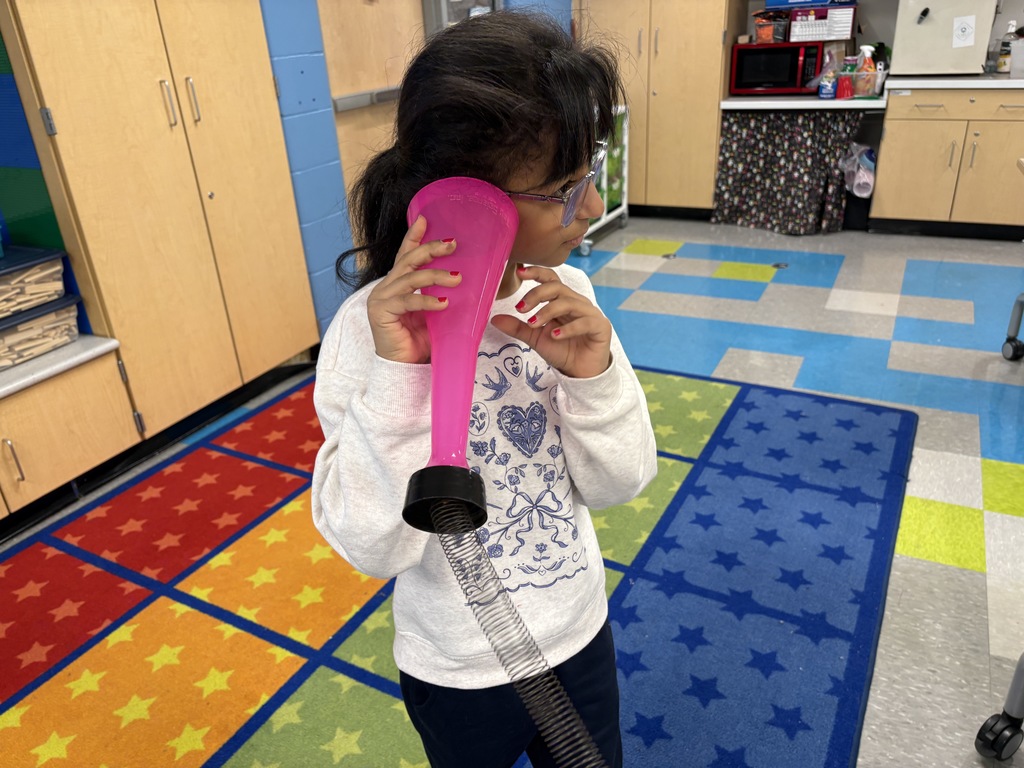 Girl holding object to her ear