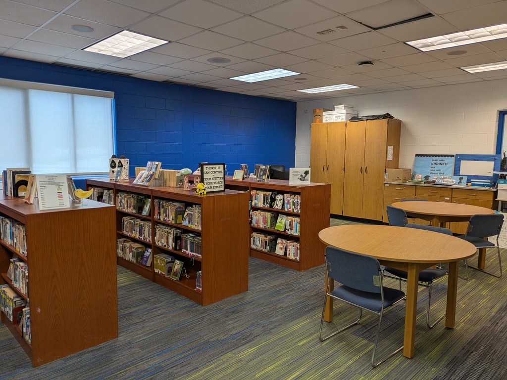 Tables with chairs and bookshelves