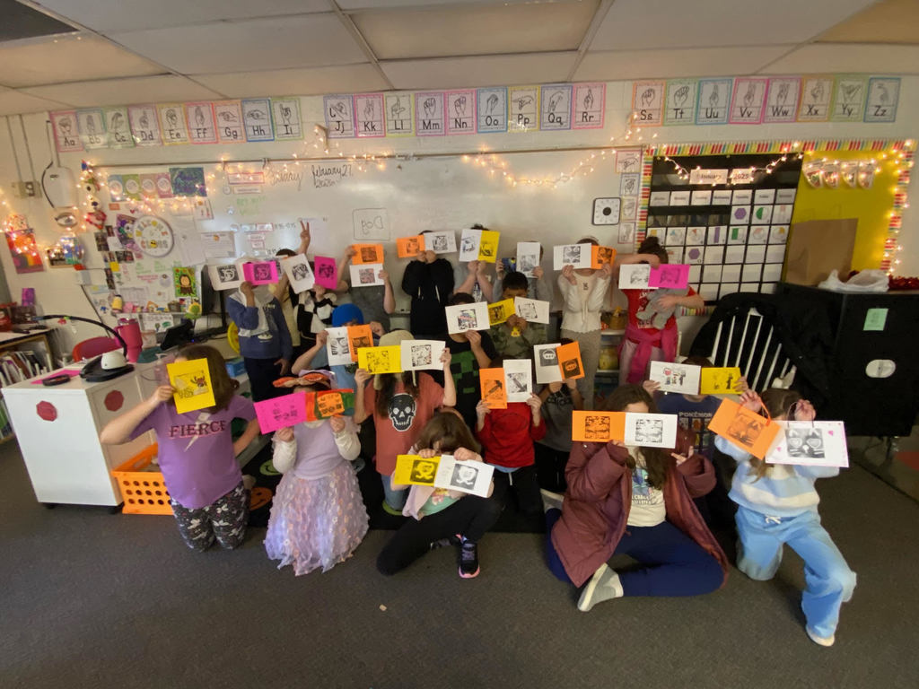 Class holding up their artwork