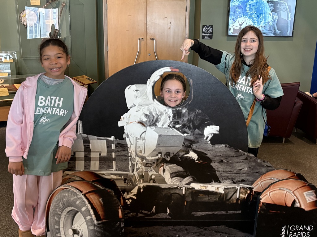 Girls standing at a space exhibit