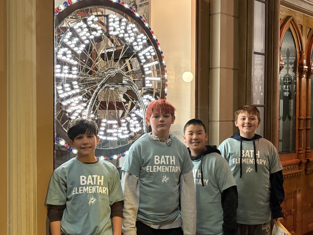 Boys standing in front a model ferris wheel