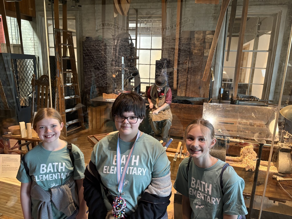 Students standing in front of an exhibit