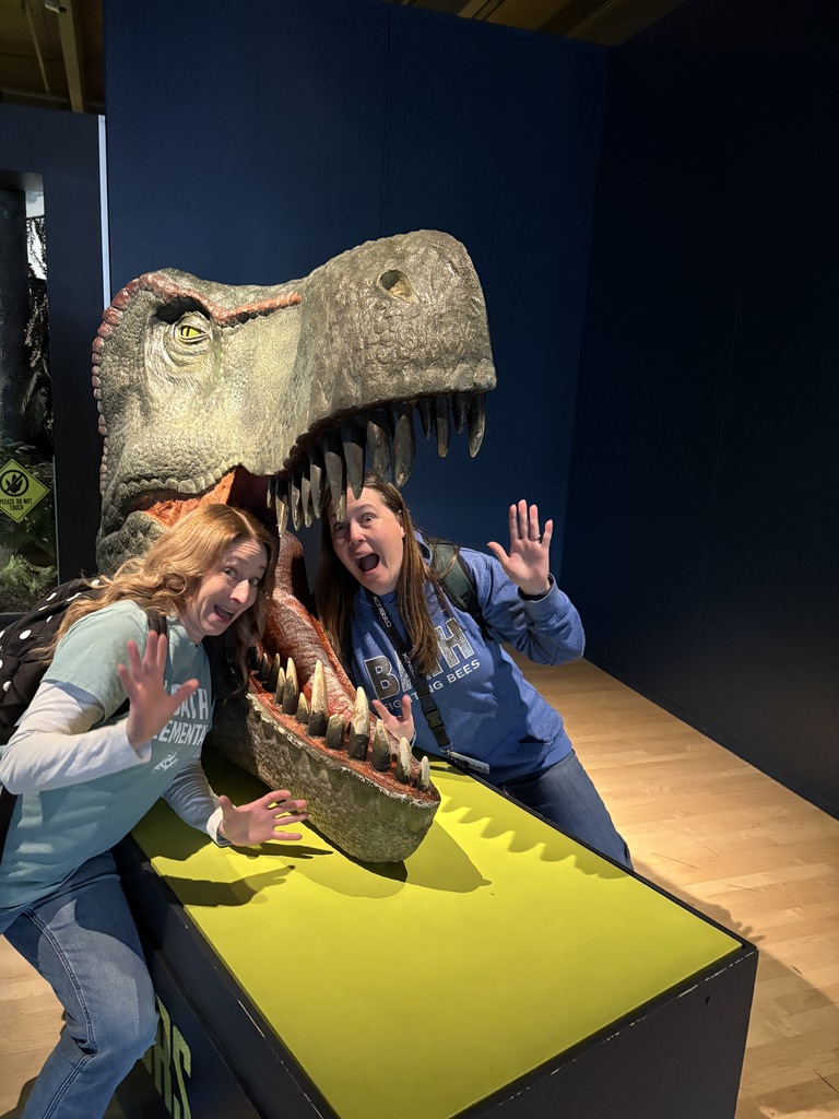 Teachers by a dinosaur head