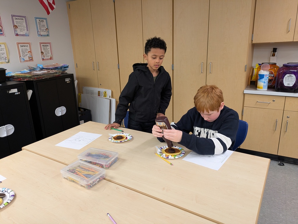 Boy putting chocolate syrup on a pancake
