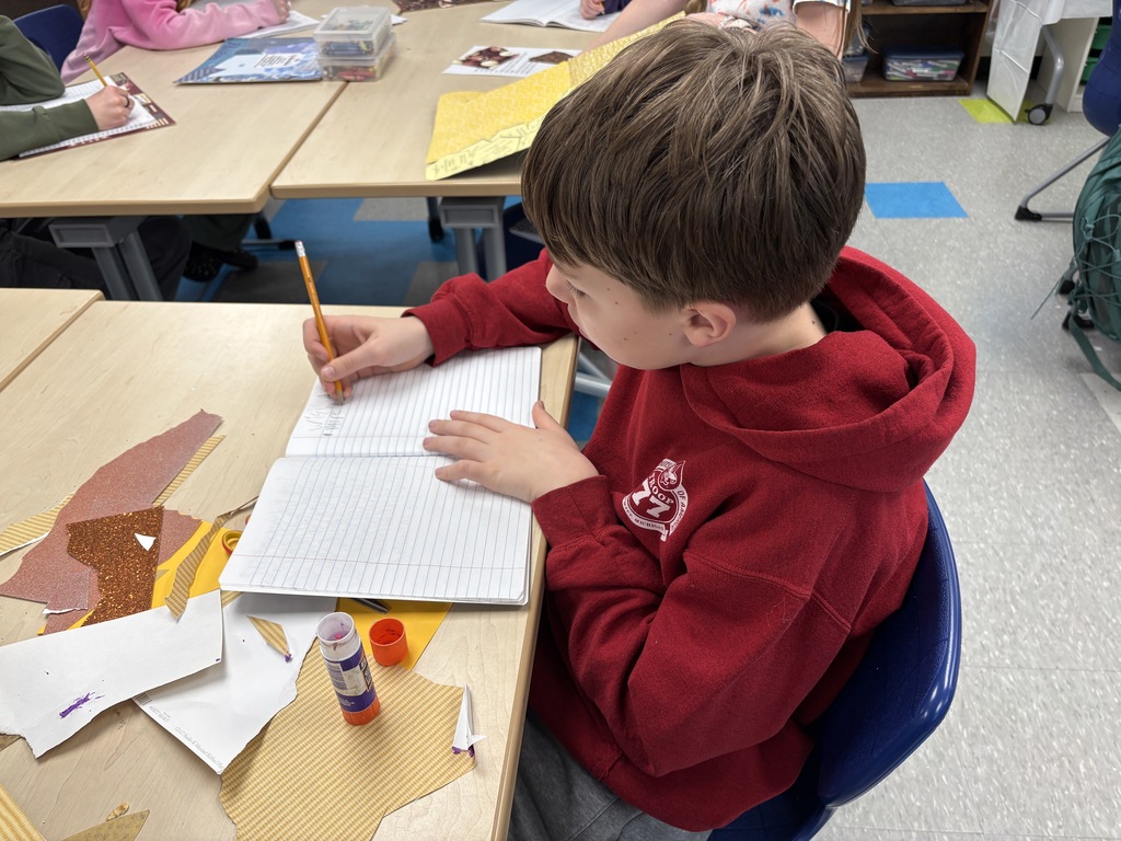 Boy writing in notebook