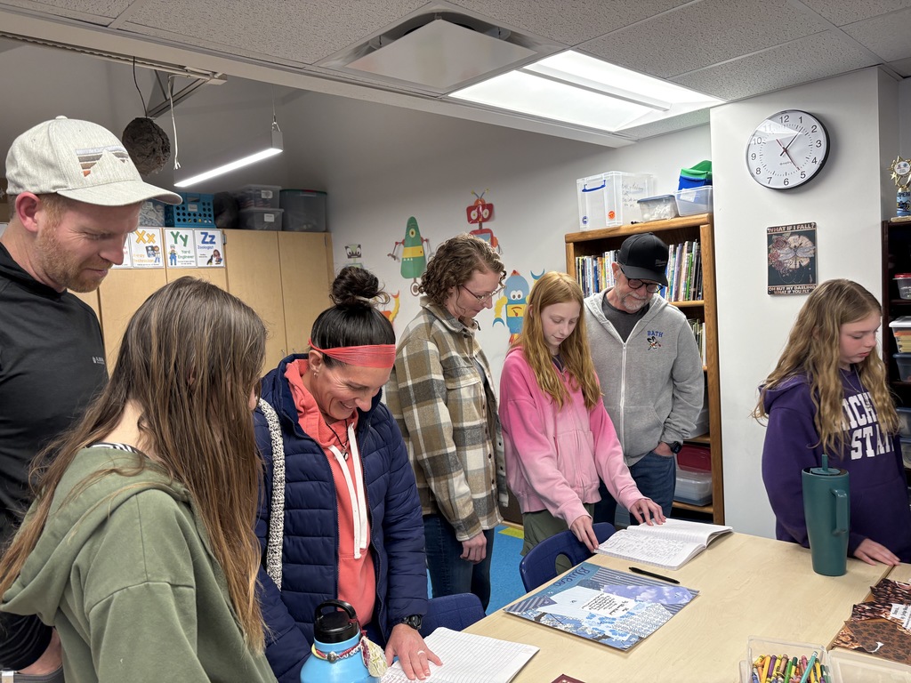 Parents and students looking at writing samples