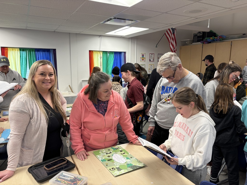 Parents and students looking at writing samples