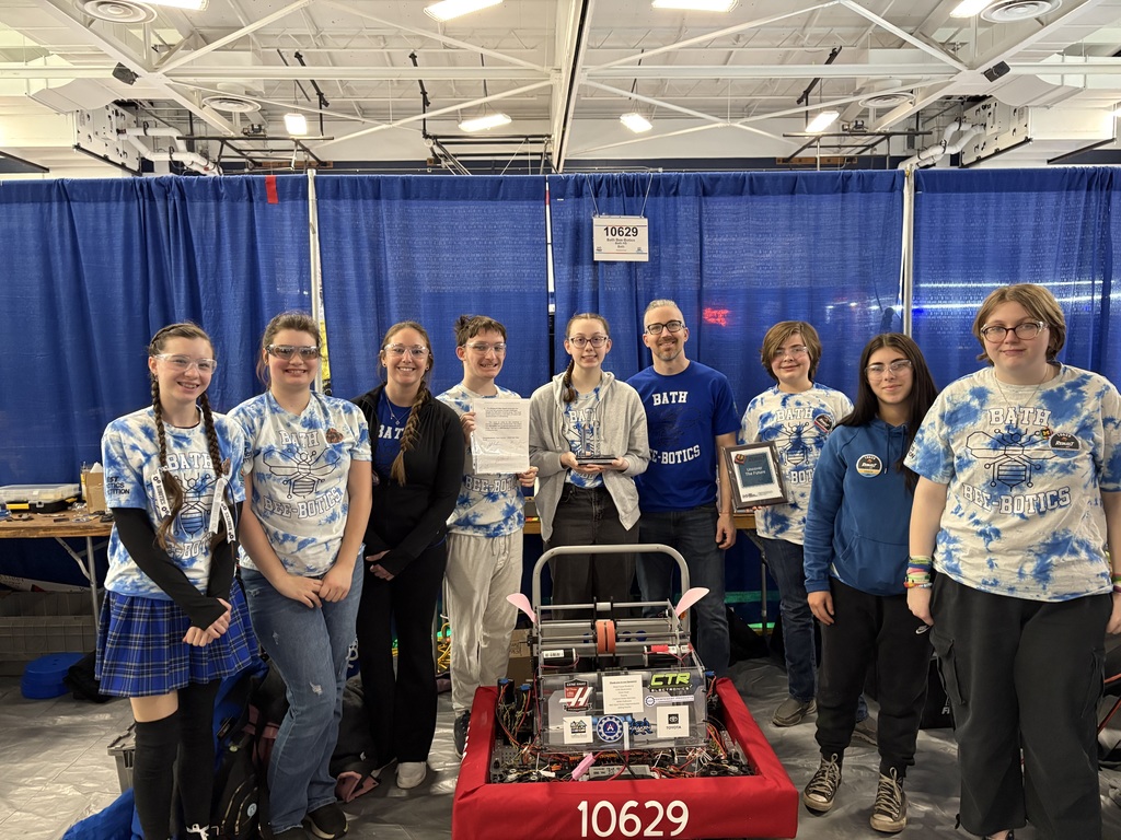 Team members standing with their robot