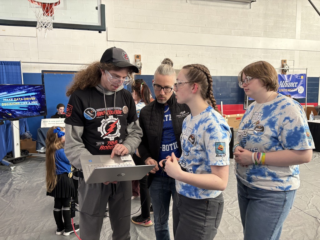Team members working on a computer