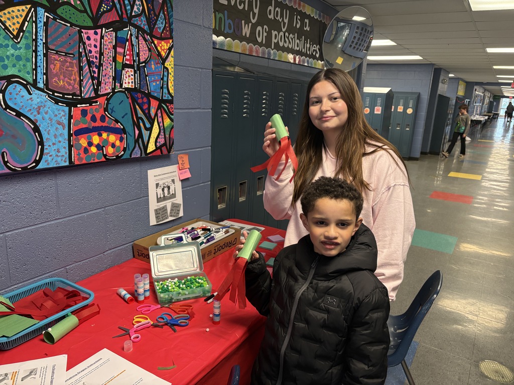 Students at table making a project