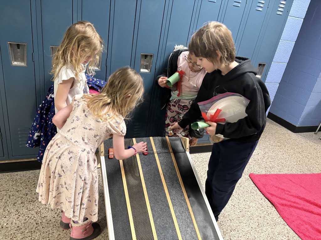 Students setting up cars on race track