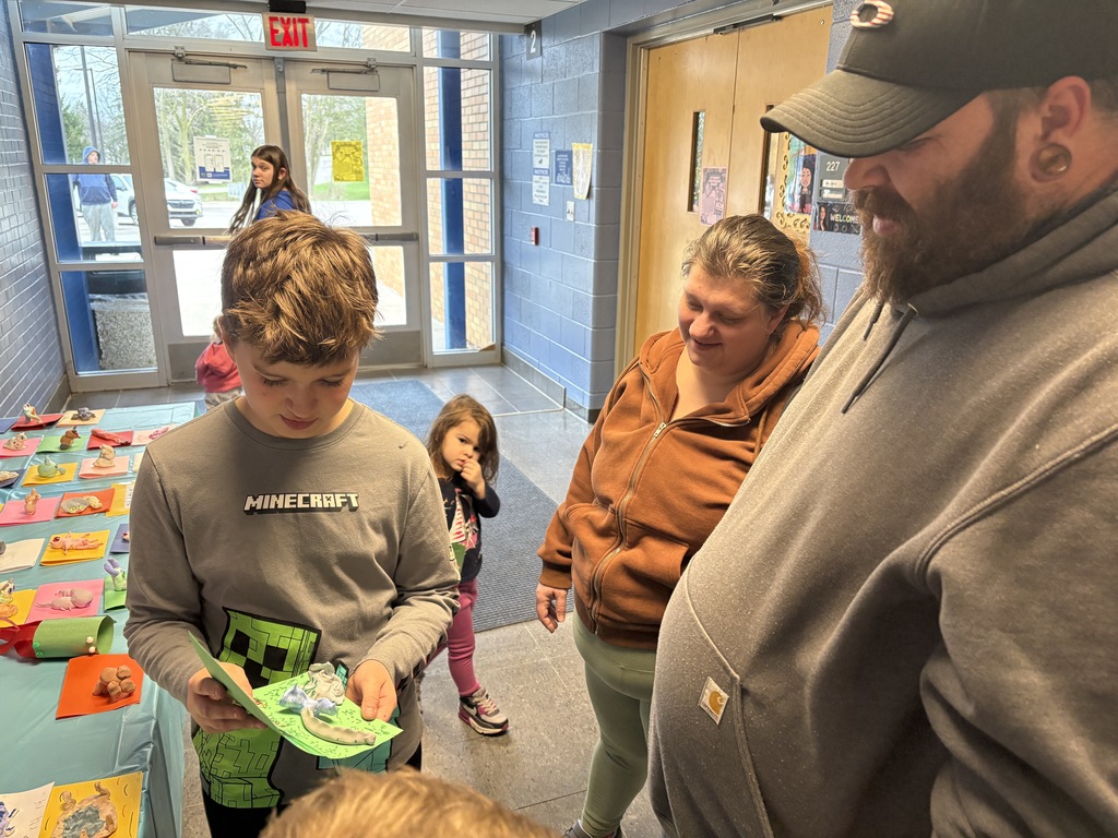 Boy looking at project with his family