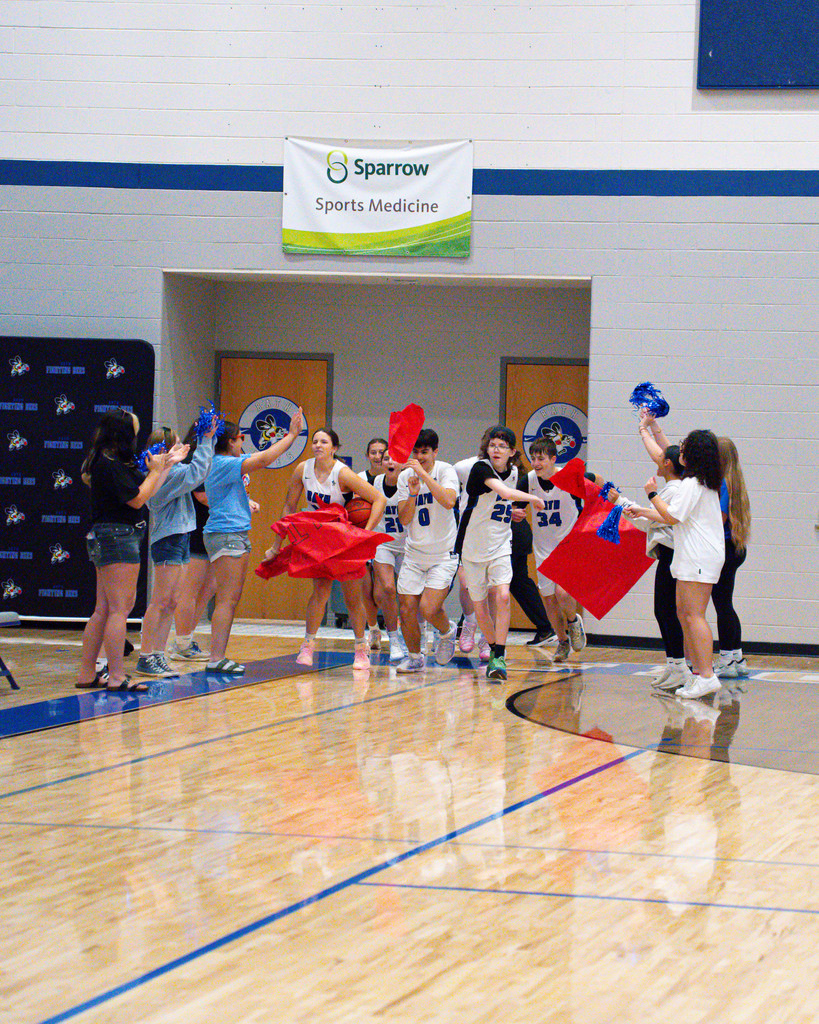 White team breaking through the banner during warm up