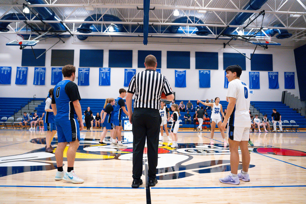 Right before tip off the teams wait for the whistle.
