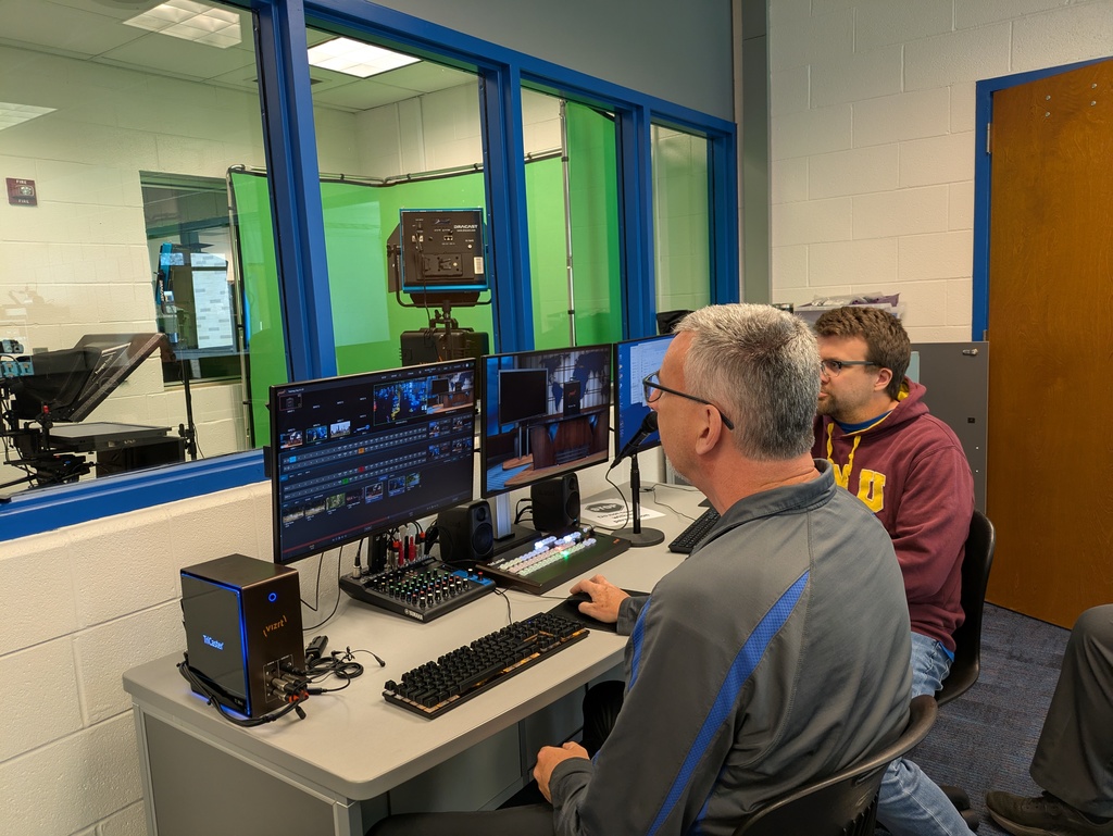 Mr. Anibal and Mr. Curl working the computer