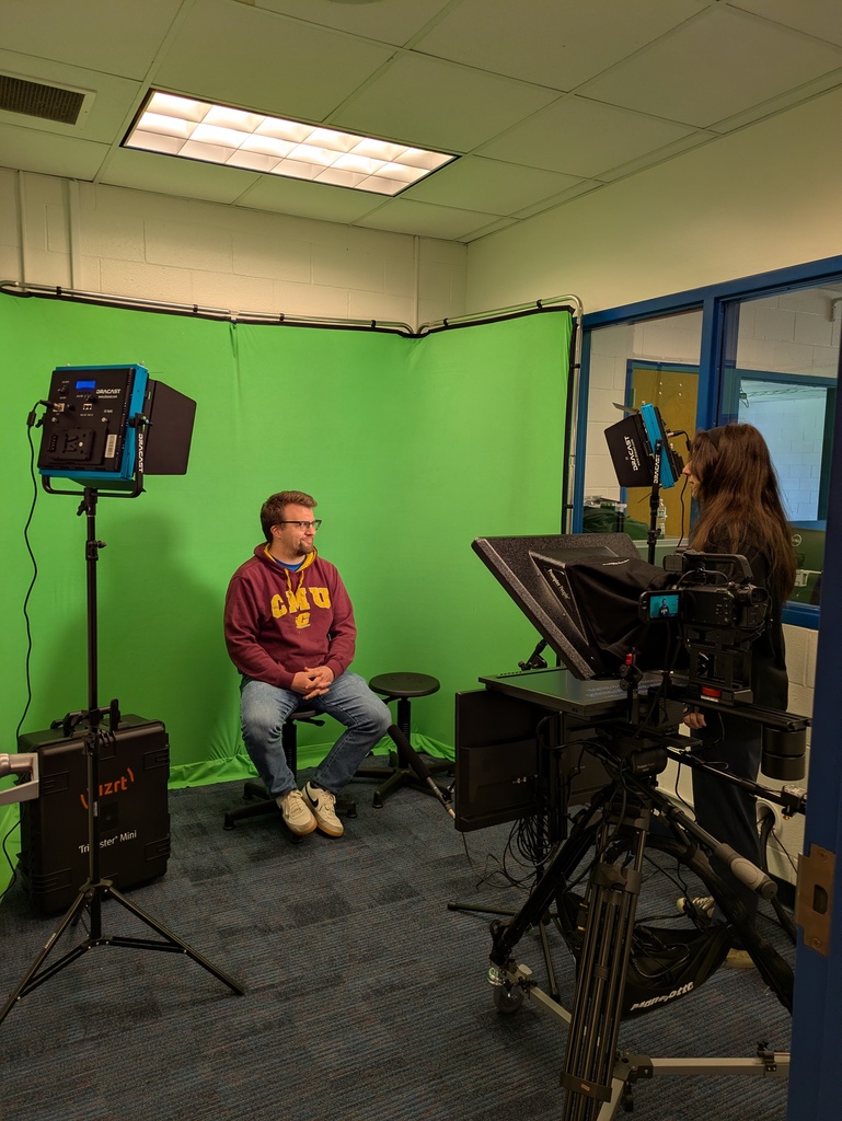 Mr. Curl sitting in front of the green screen