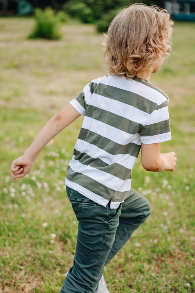 Boy running in the grass