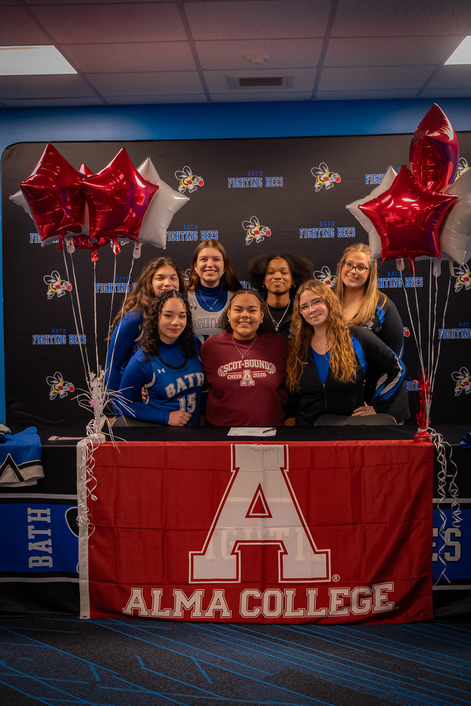 High school cheerleaders at signing ceremony