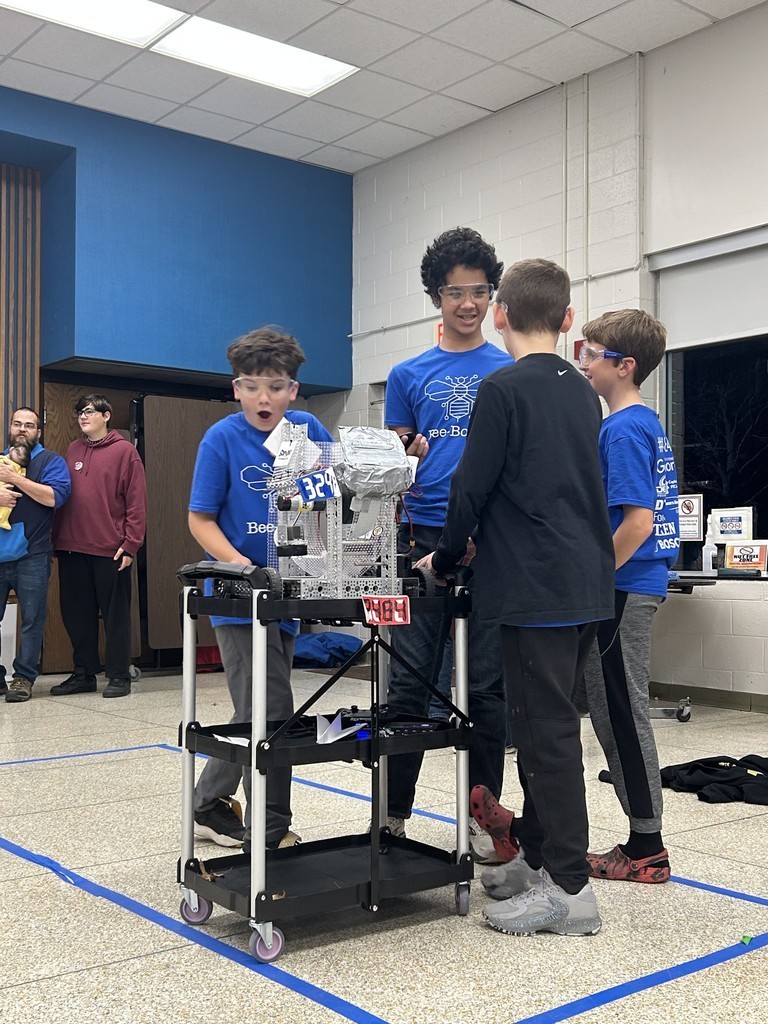 Boys standing in front of Robot