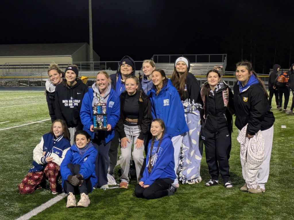 Members of the girls track team with a trophy