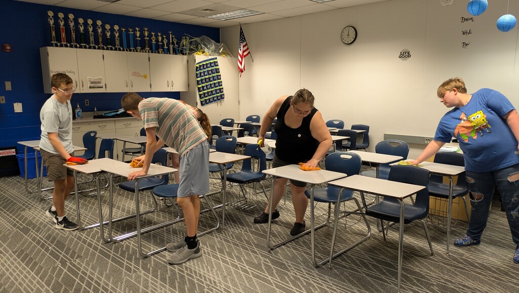 Students wiping down desks