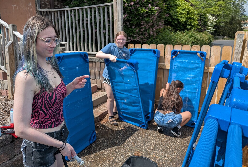 Girls cleaning cots
