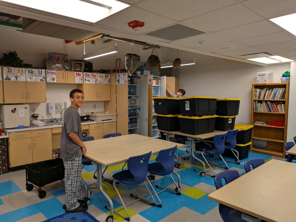 Students moving tubs at the elementary school