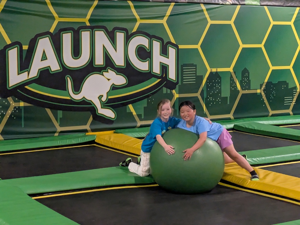 Girls laying on large ball