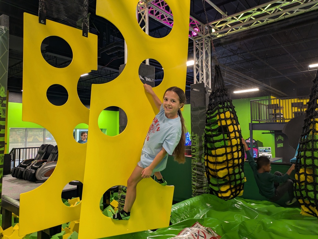 Girl hanging on climber