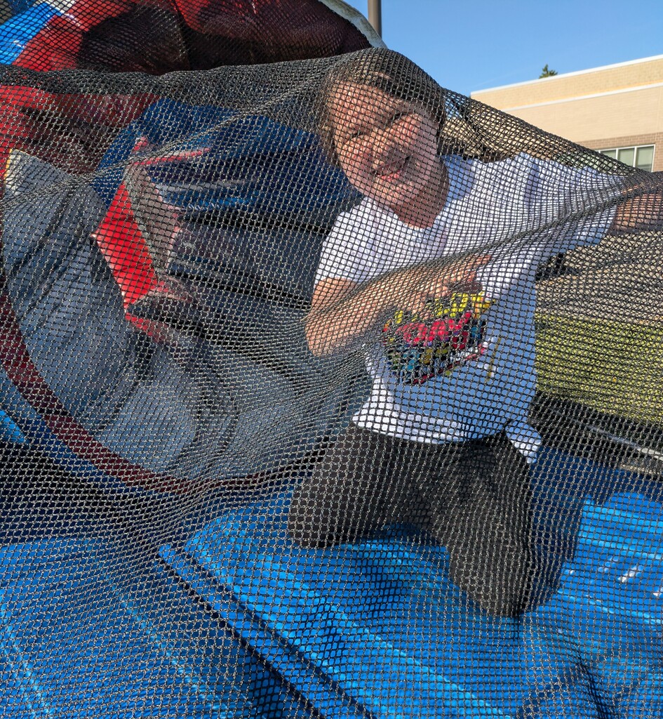 Girl under net on bounce house