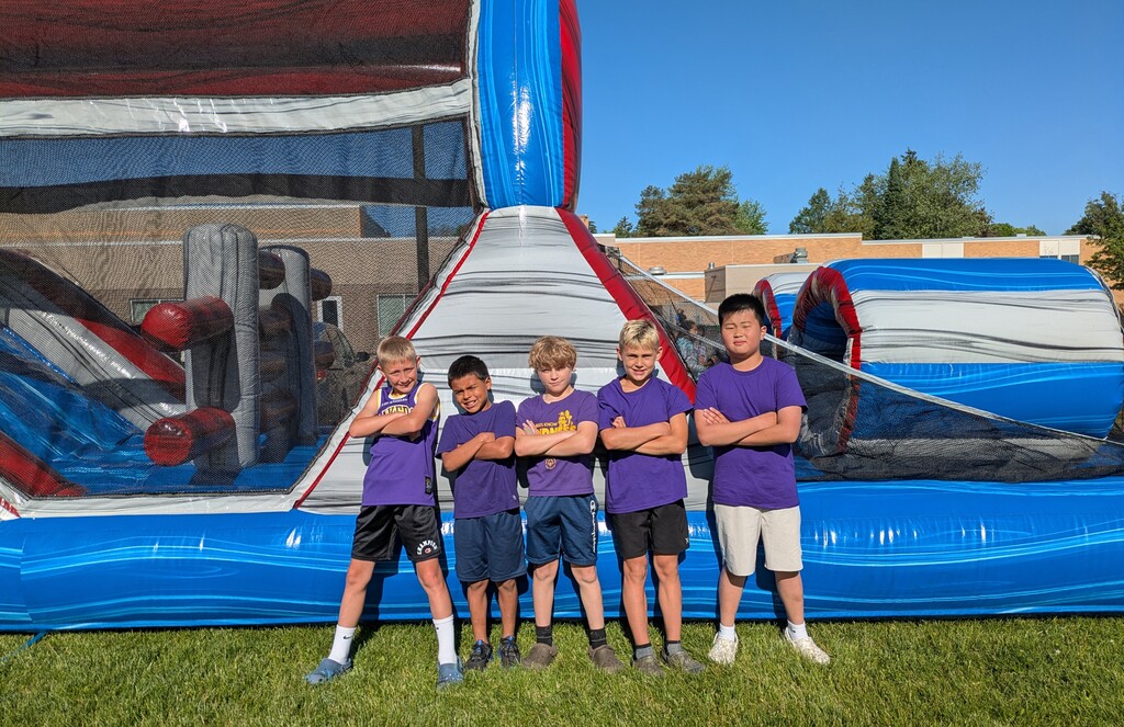 Boys standing in front of bounce house