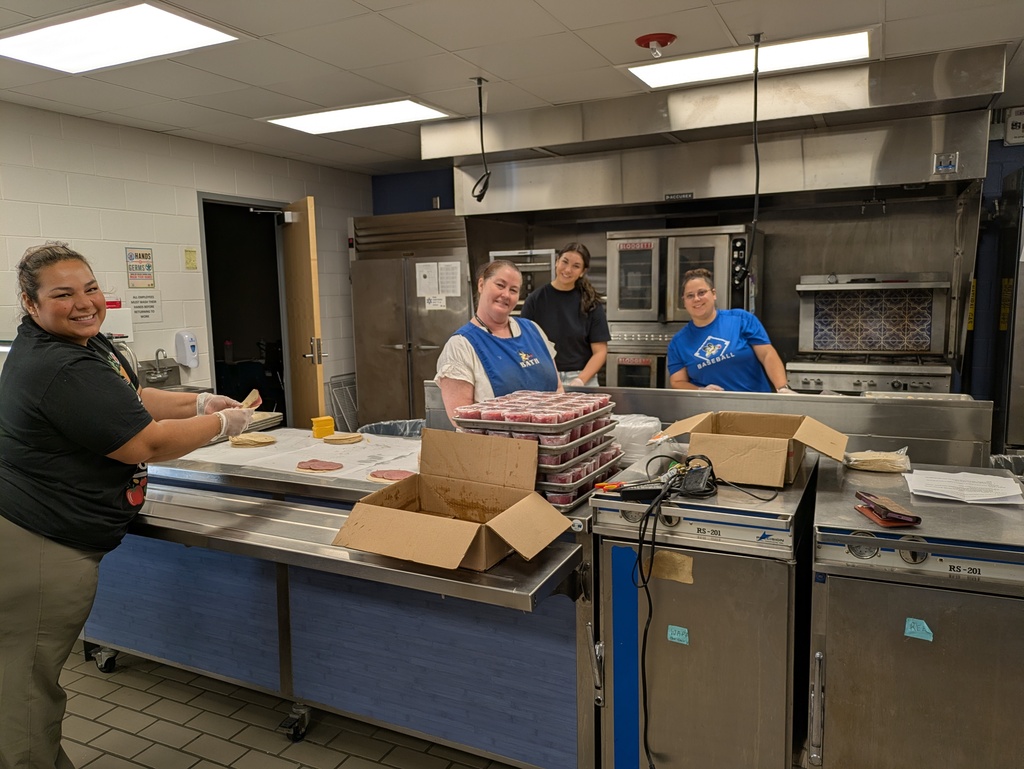 Food service staff preparing lunches for students