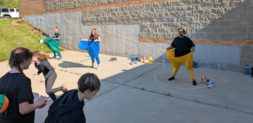Students wearing big pants to catch balls