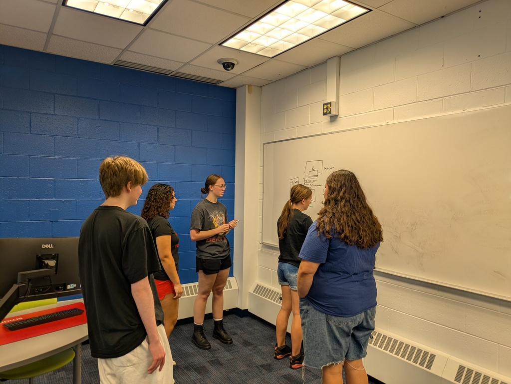Students standing at a white board