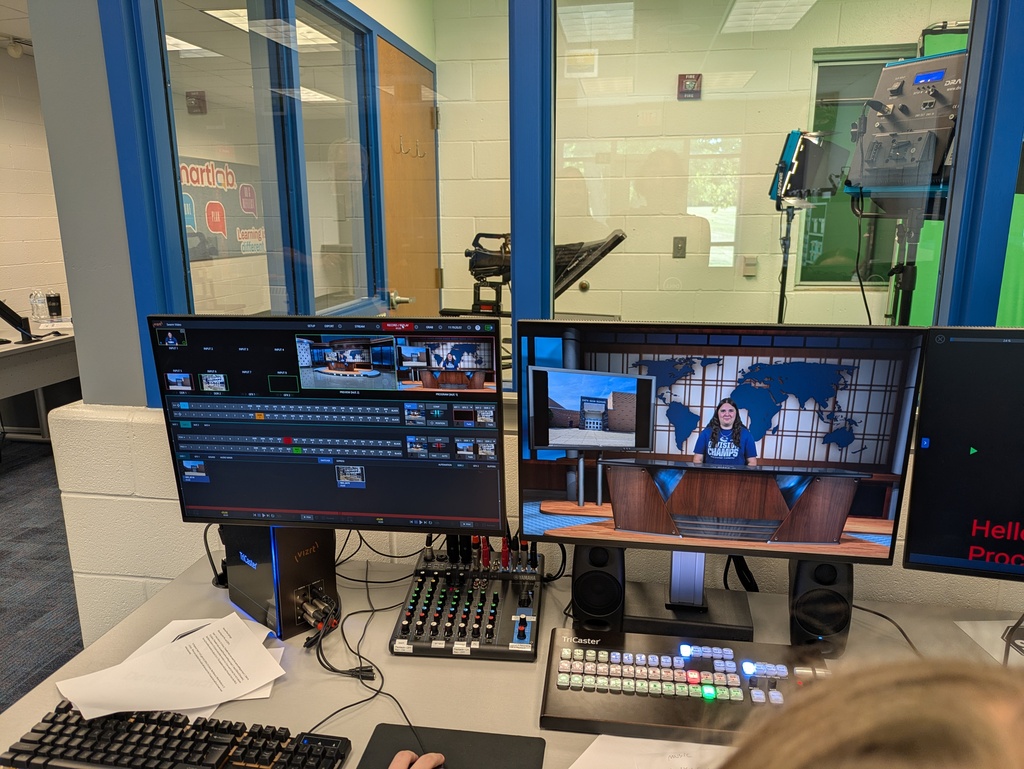 Studio computers showing student in newsroom