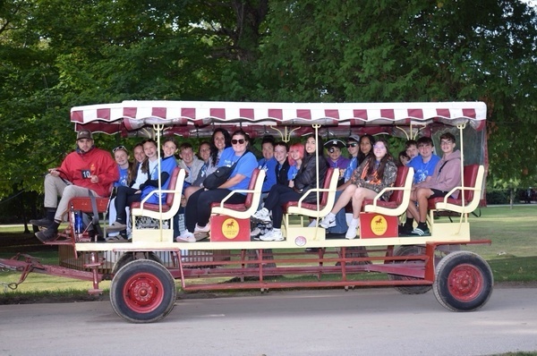 Students sitting on a wagon.