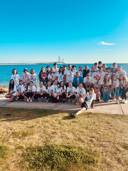 Students standing in front of Lake Michigan and the Mackinac Bridge