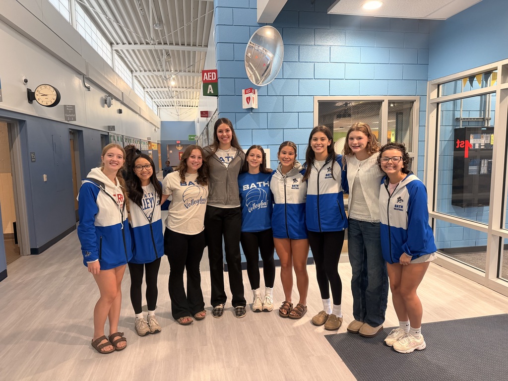 Volleyball team members standing in the lobby 