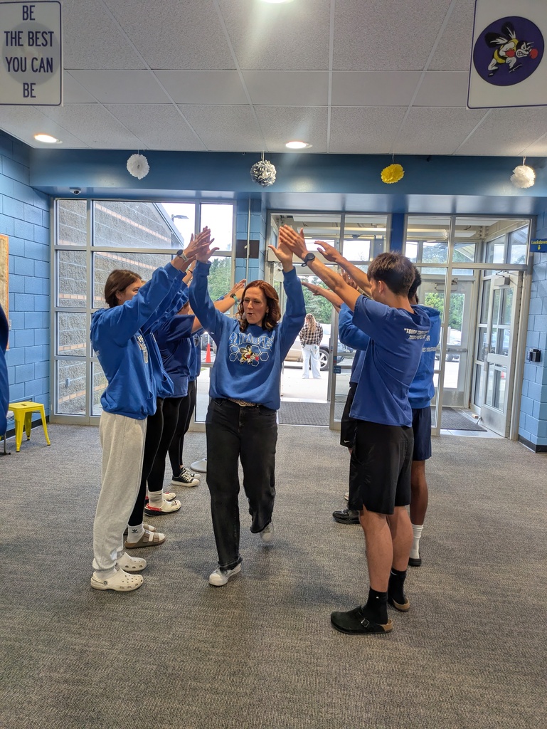 Mrs. Sykes walking through tunnel of students