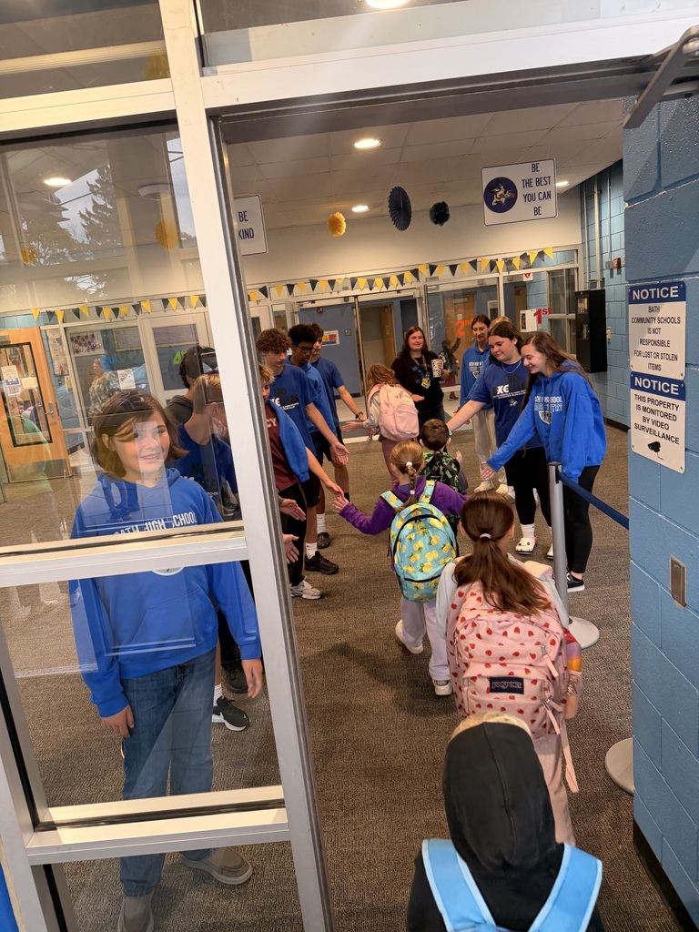 Elementary students giving cross country team a high 5