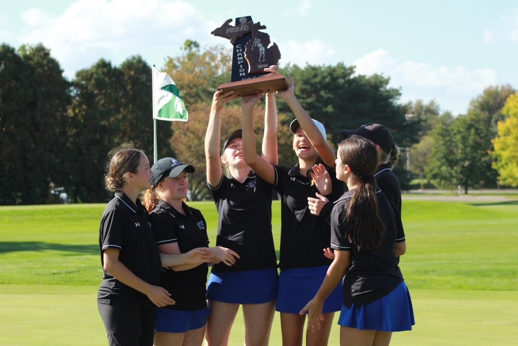 Girls team players holding up a trophy