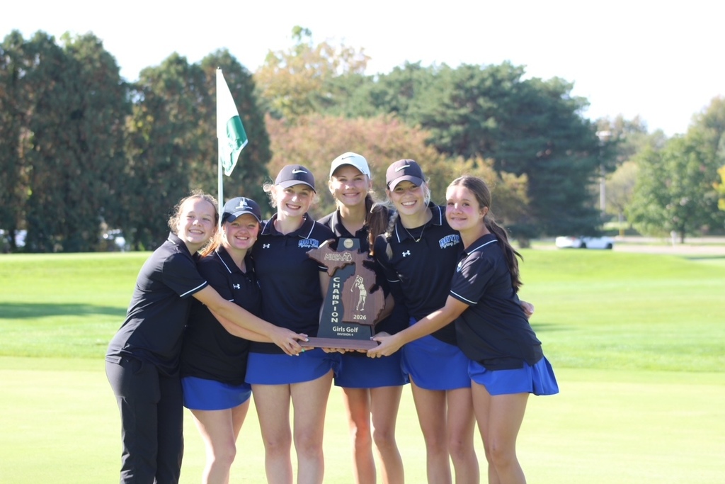 Girls golf team players standing together holding the regional trophy