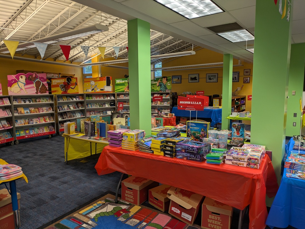 Table with red table cloth with books displayed for purchase