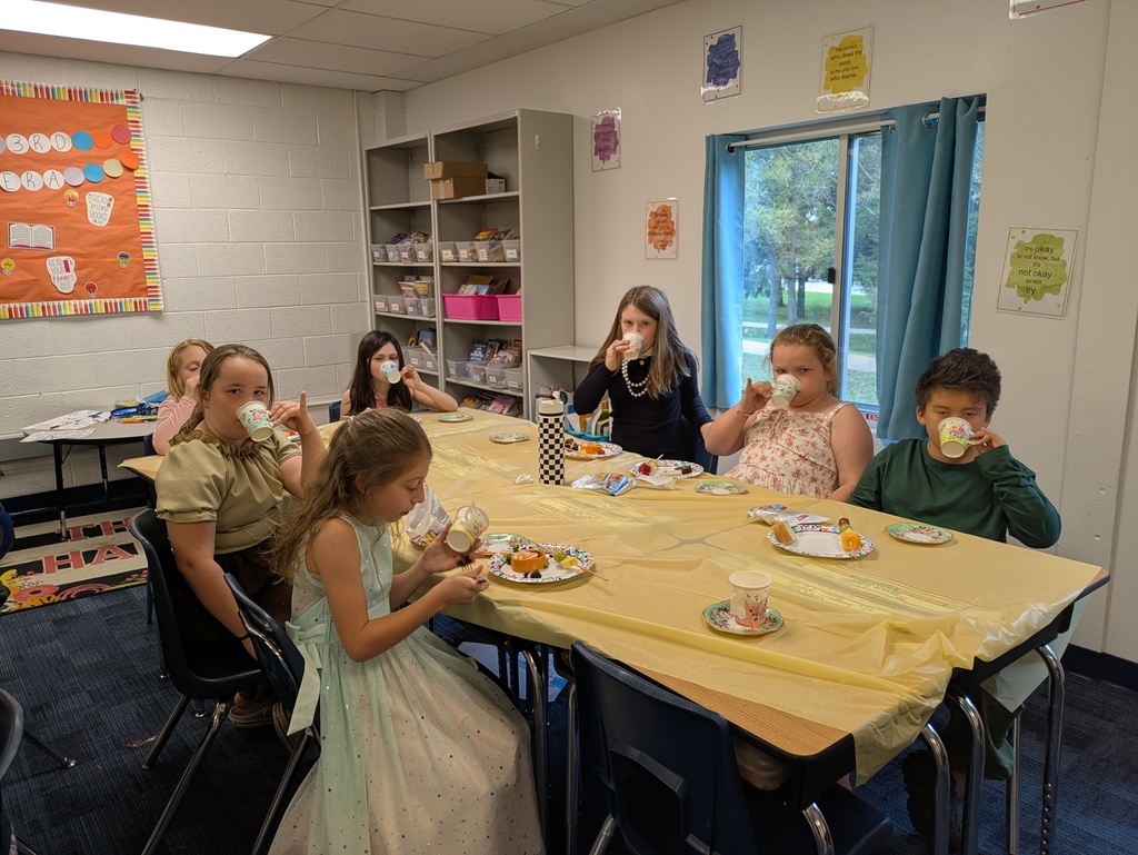 A group of students dressed up drinking out of fancy cups