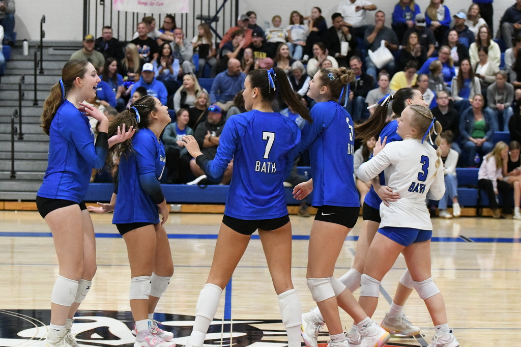 Team members on the court celebrating